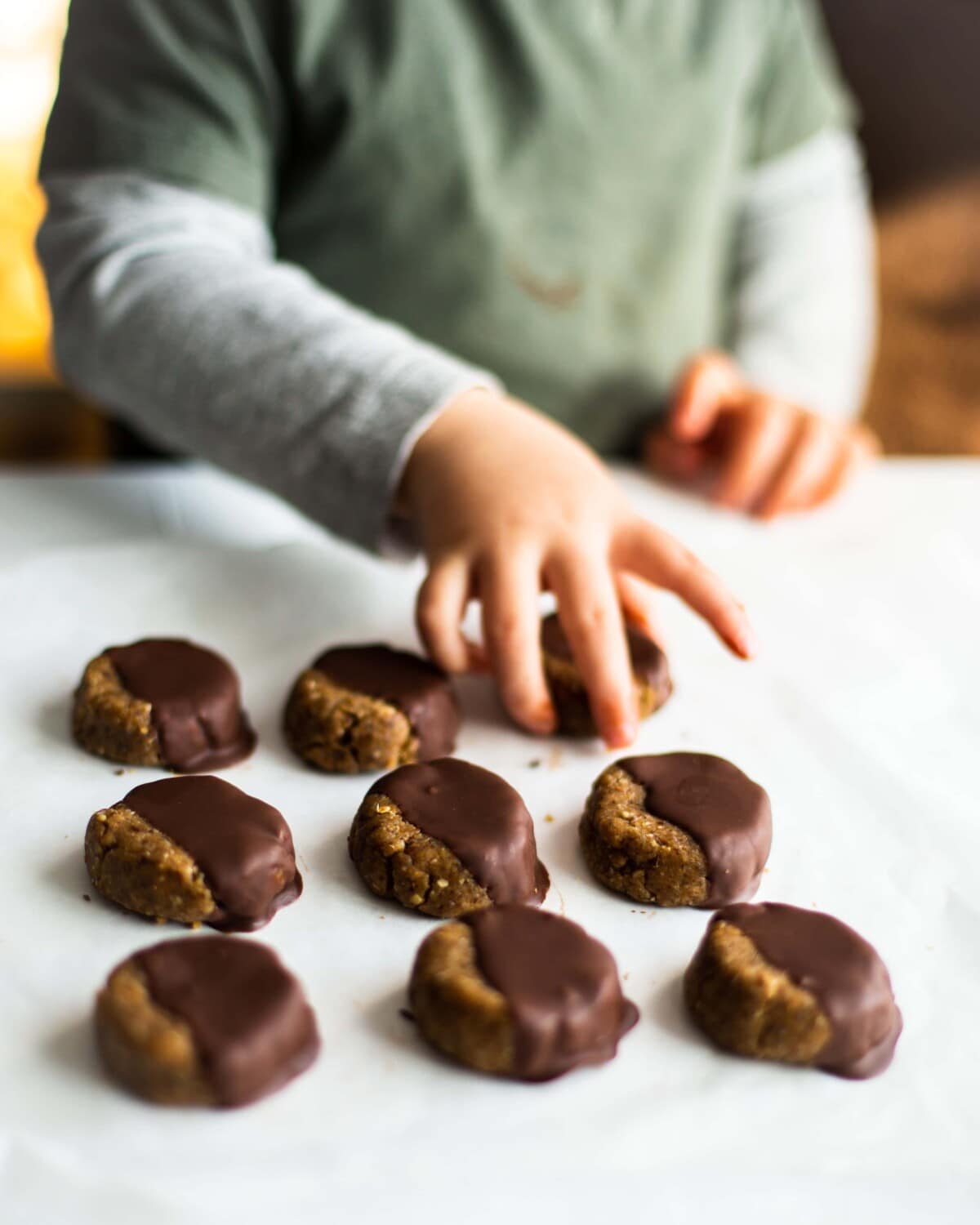 My toddler helping himself to some freshly dipped chocolate cookies