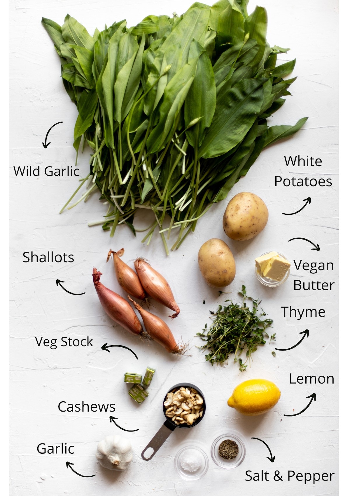 Wild garlic soup ingredients all laid out on a white background and photographed from above..