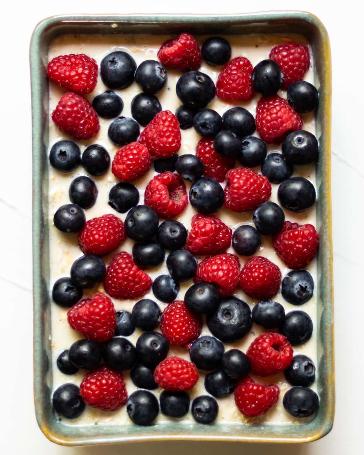 The baked oats mixture topped with berries prior to baking.