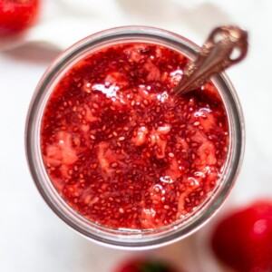 An overhead close up view of the strawberry chia jam in a jar.