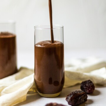 Pouring the smoothie in to a glass.