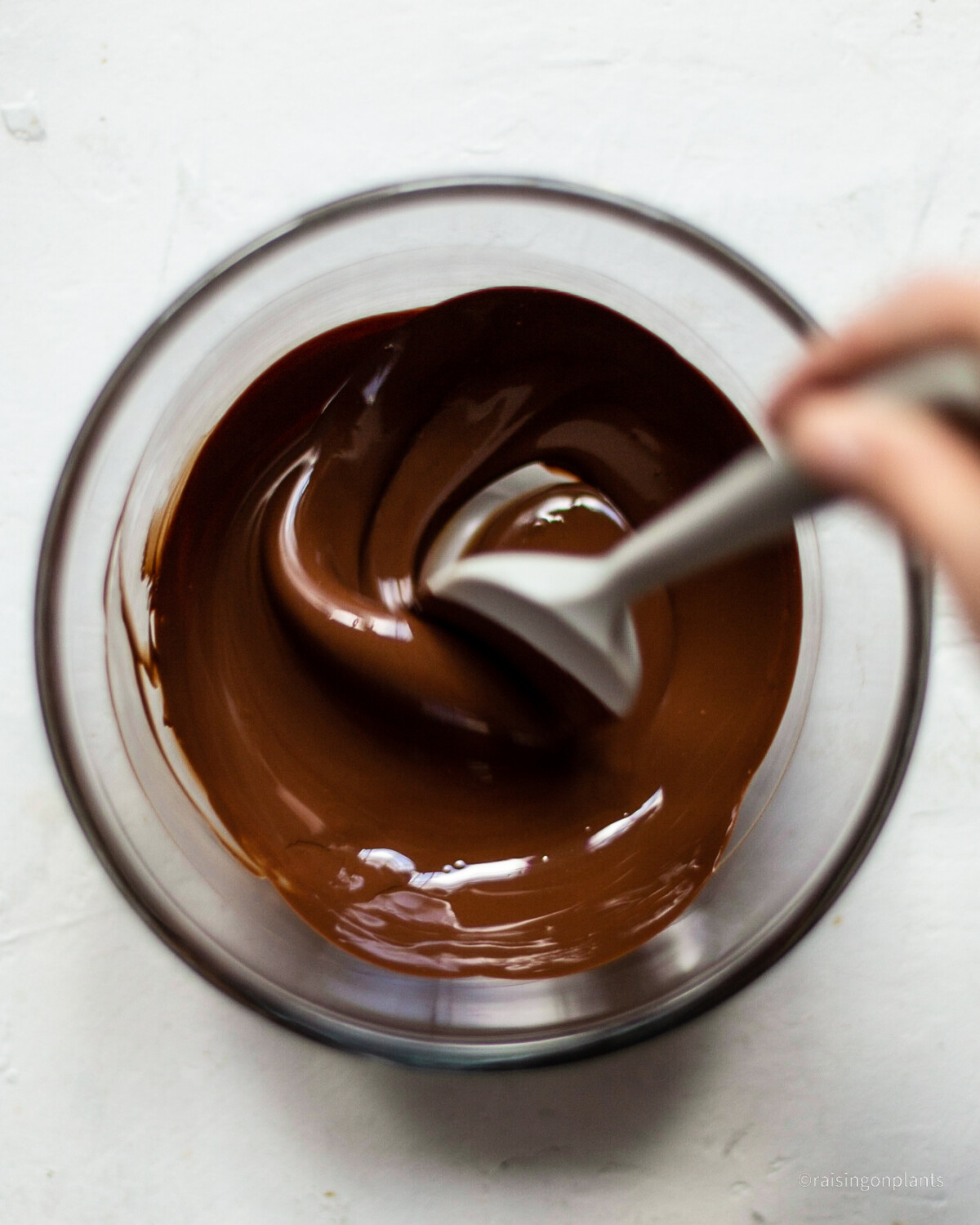 Melted chocolate in a glass bowl.